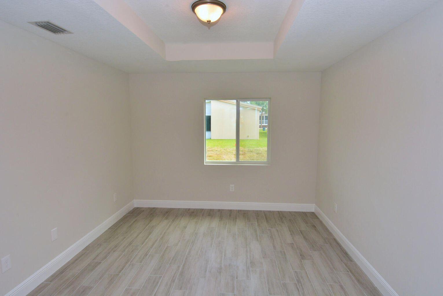 4335 Southwest 15th Way Okeechobee, FL 34974 - Photo 6 of 14 a view of a room that has wooden floor and cabinets