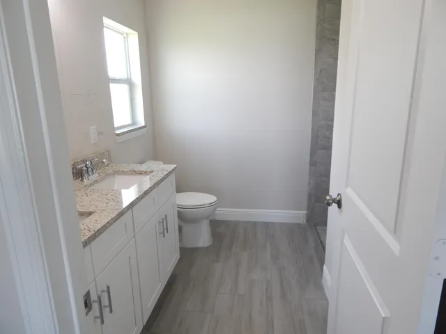a bathroom with a sink a toilet and tub