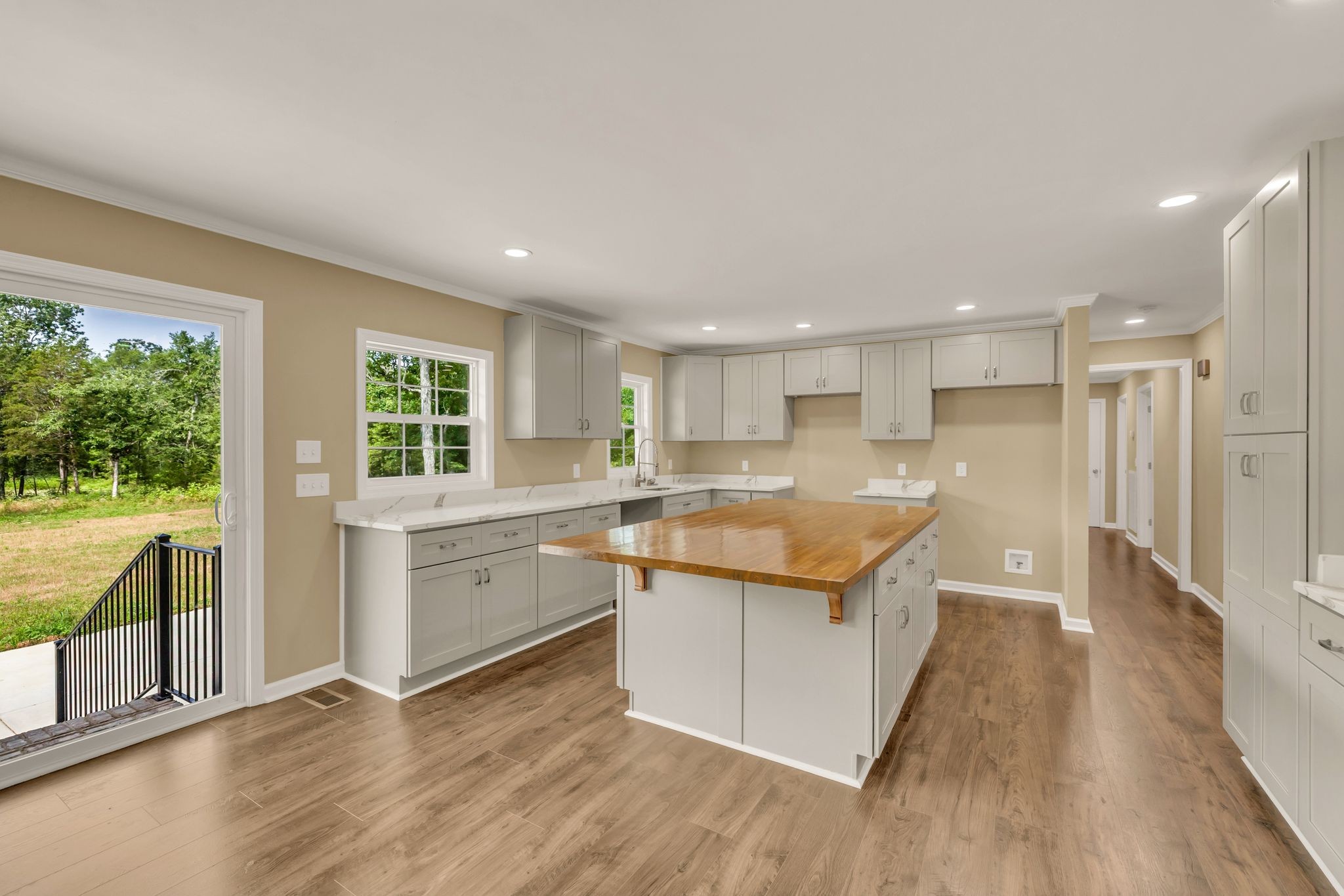 5065 Craddock Road Lascassas, TN 37085 - Photo 12 of 51 a kitchen with a refrigerator a sink dishwasher with a dining table and chairs with wooden floor