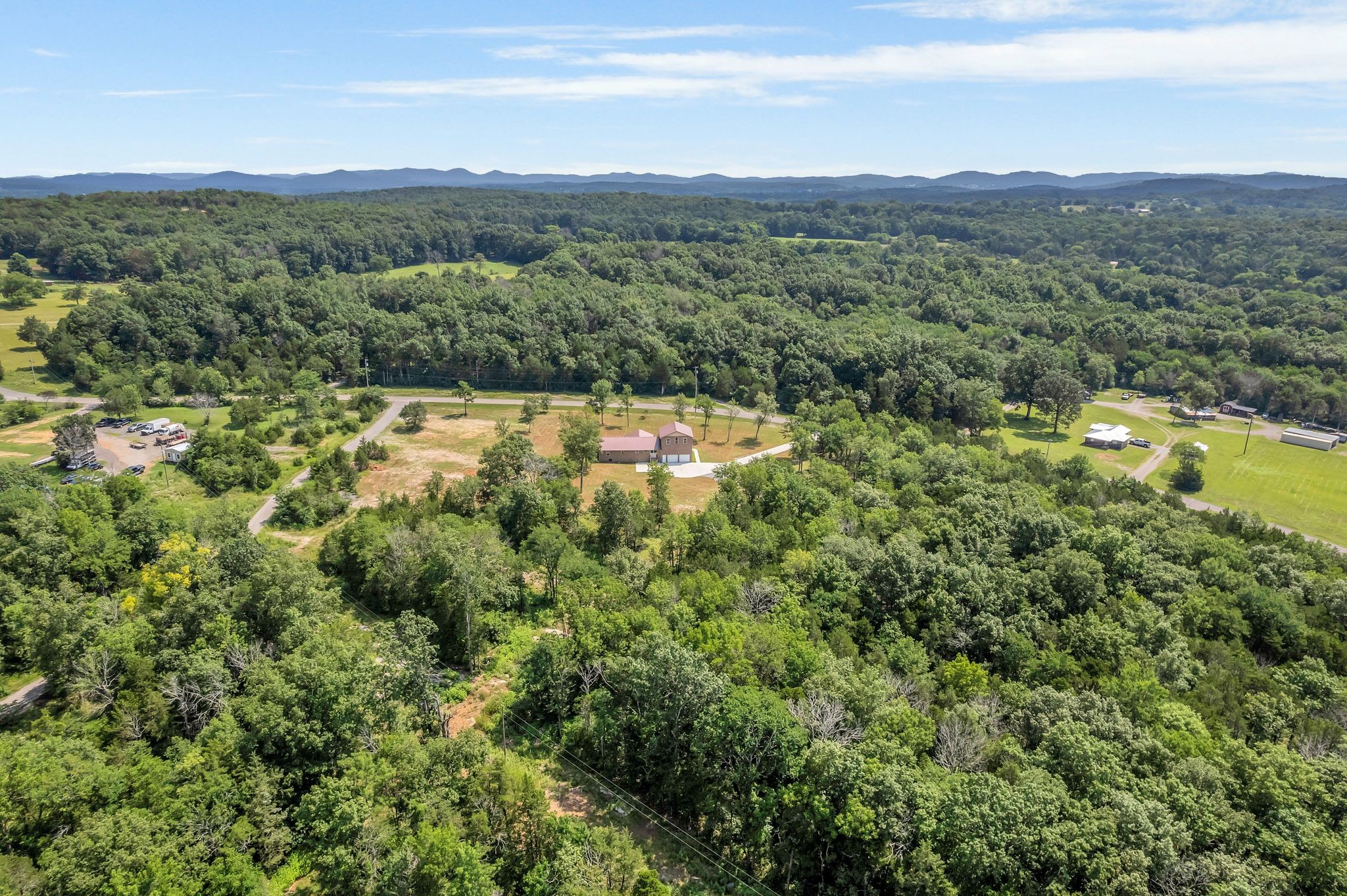 5065 Craddock Road Lascassas, TN 37085 - Photo 49 of 51 a view of a lush green forest with trees and houses