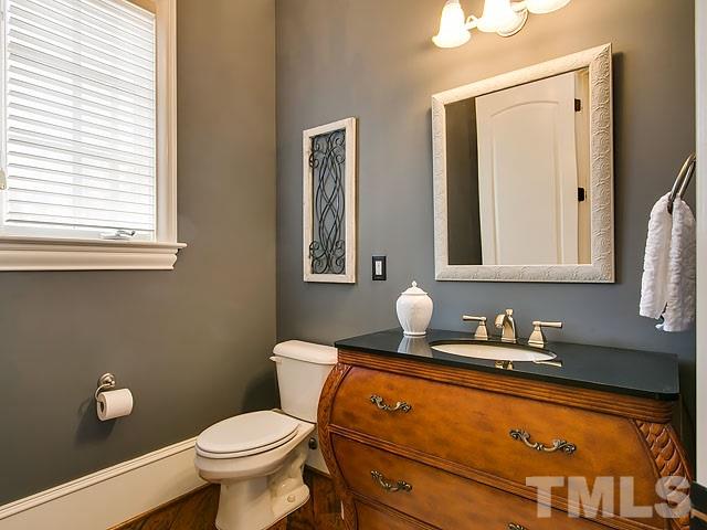6037 Over Hadden Court Raleigh, NC 27614 - Photo 12 of 25 a bathroom with a granite countertop toilet sink and mirror