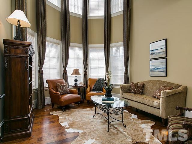 6037 Over Hadden Court Raleigh, NC 27614 - Photo 13 of 25 a living room with furniture and a floor to ceiling window