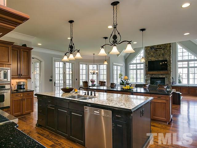6037 Over Hadden Court Raleigh, NC 27614 - Photo 14 of 25 a kitchen with granite countertop a sink stove and cabinets