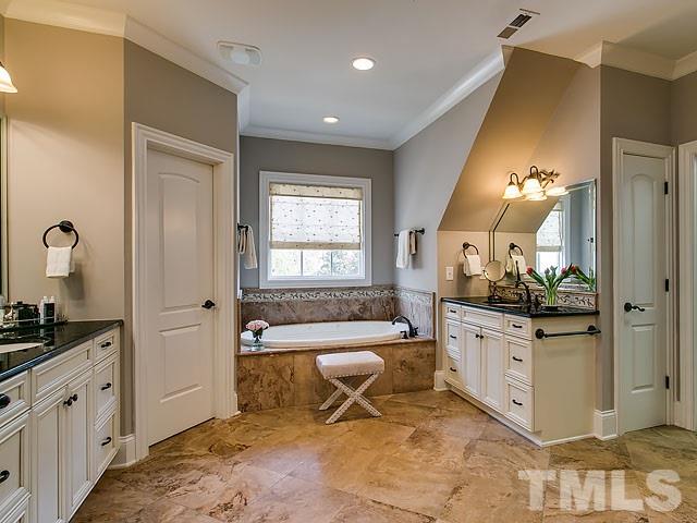 6037 Over Hadden Court Raleigh, NC 27614 - Photo 18 of 25 a spacious bathroom with a granite countertop sink a mirror and a bathtub