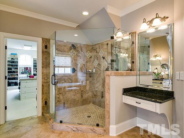 6037 Over Hadden Court Raleigh, NC 27614 - Photo 19 of 25 a bathroom with a granite countertop sink a mirror and shower