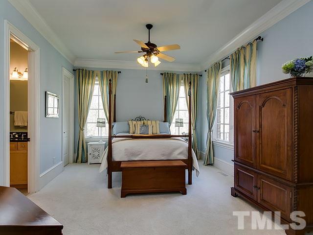 6037 Over Hadden Court Raleigh, NC 27614 - Photo 21 of 25 a spacious bedroom with a bed and a chandelier