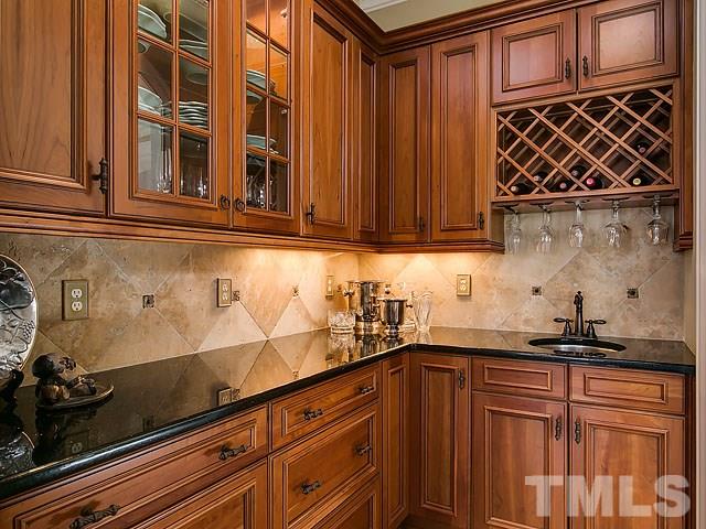 6037 Over Hadden Court Raleigh, NC 27614 - Photo 8 of 25 a kitchen with granite countertop cabinets and black appliances