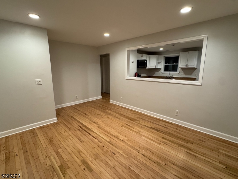 2 Woodside Avenue, Unit 1 Little Falls, NJ 07424 - Photo 1 of 13 a view of empty room with wooden floor