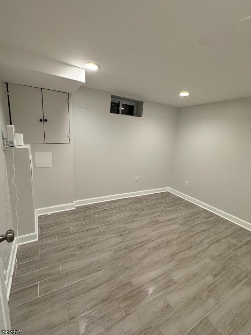 2 Woodside Avenue, Unit 1 Little Falls, NJ 07424 - Photo 11 of 13 a view of a room with wooden floors and white walls