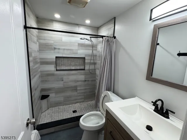 a bathroom with a sink toilet and shower