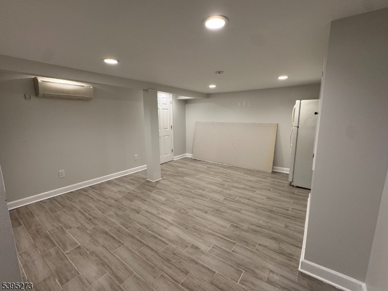 2 Woodside Avenue, Unit 1 Little Falls, NJ 07424 - Photo 7 of 13 an empty room with wooden floor and windows