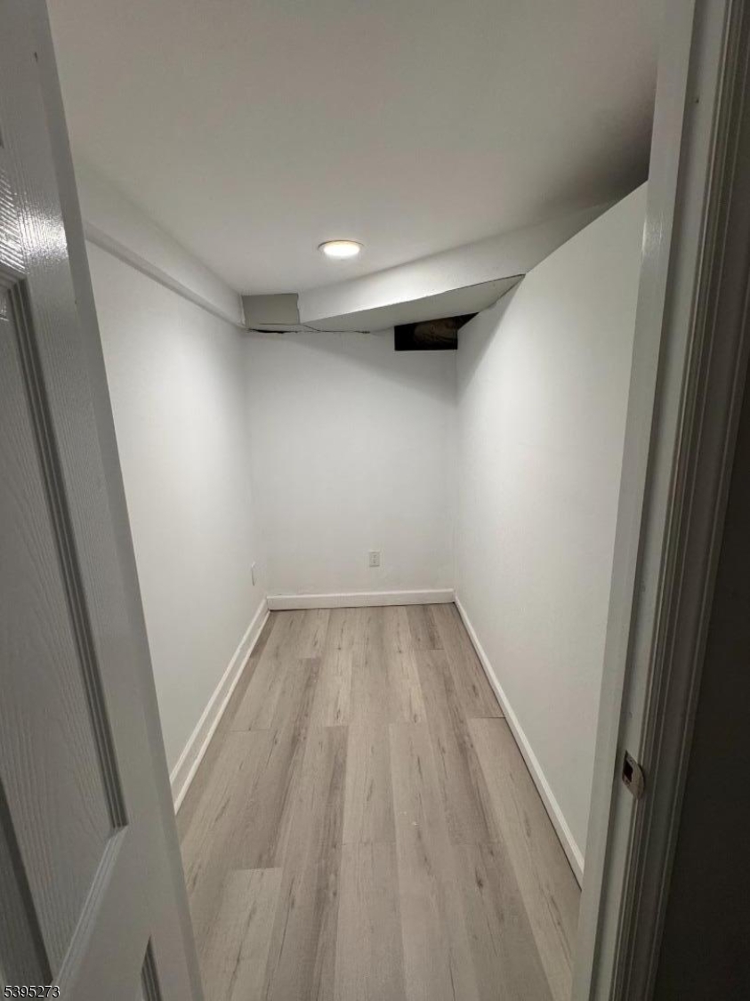 2 Woodside Avenue, Unit 1 Little Falls, NJ 07424 - Photo 9 of 13 en empty room with wooden floor