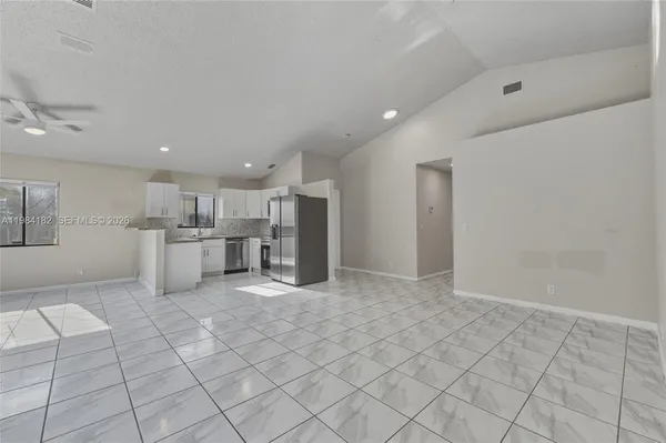 a view of kitchen with white cabinets