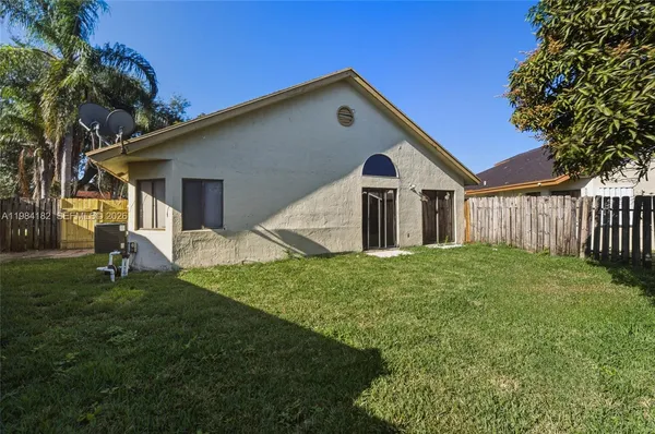 a front view of house with a garden