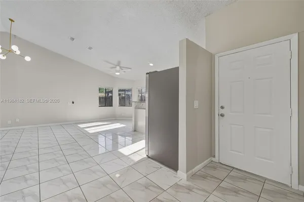 a view of a kitchen with white cabinets