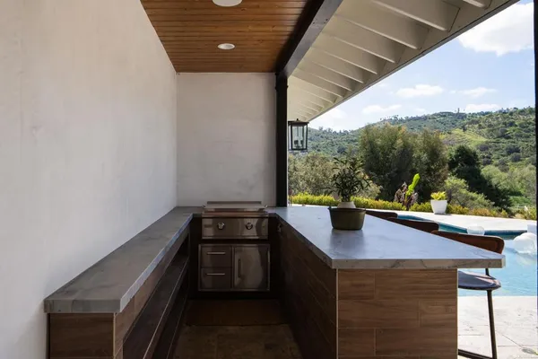 a kitchen with a sink and large window