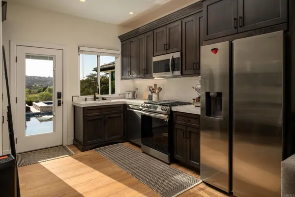 a kitchen with stainless steel appliances a refrigerator and a stove