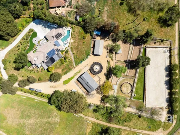 an aerial view of residential house with outdoor space and swimming pool
