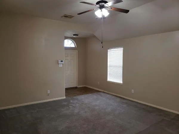 a view of an empty room with a window