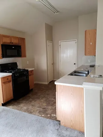 a kitchen with a sink and a stove top oven