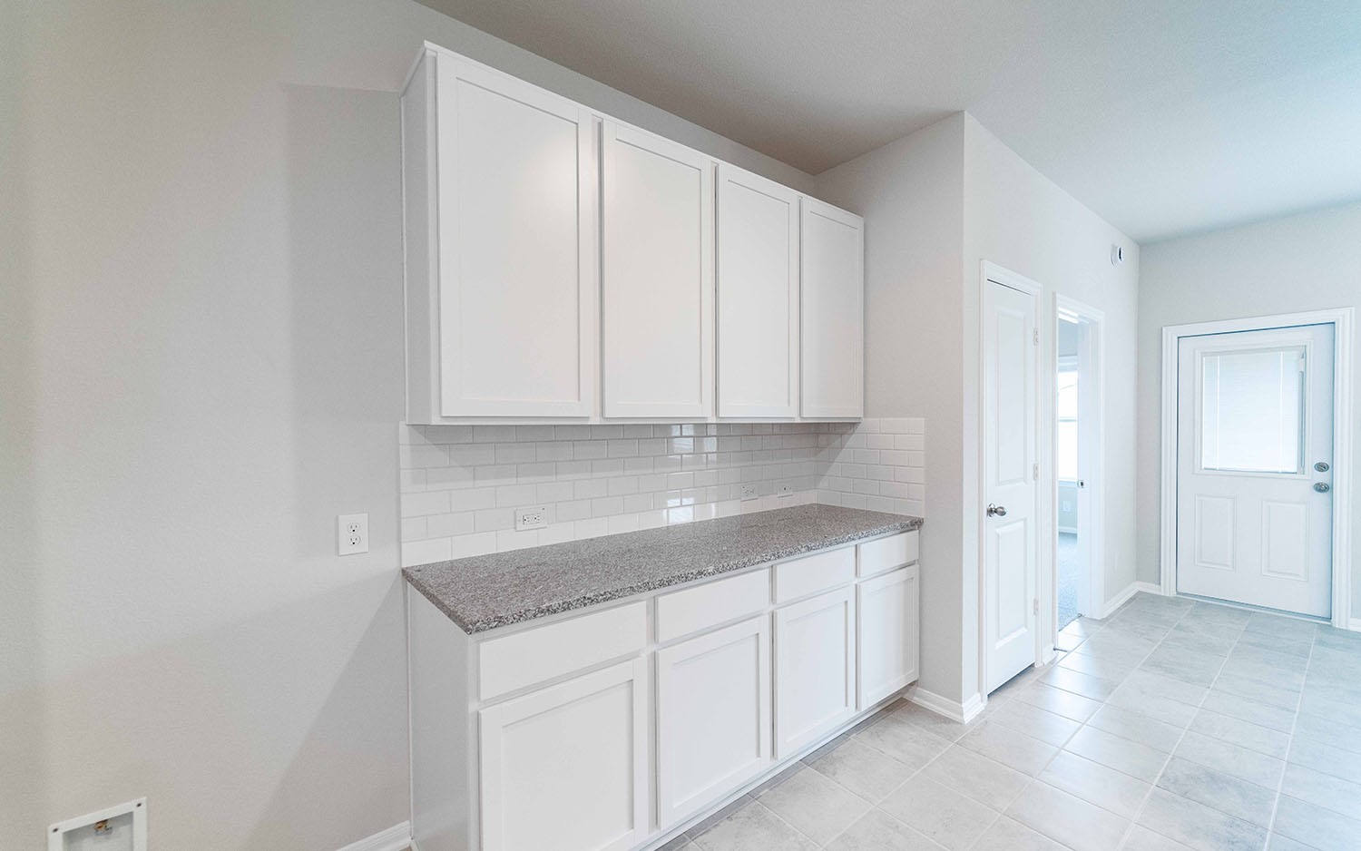 22222 Rome Breeze Drive Hockley, TX 77447 - Photo 7 of 16 a view of a kitchen with white cabinets