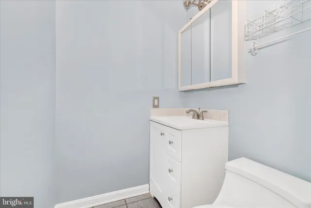 a utility room with a sink a toilet and vanity