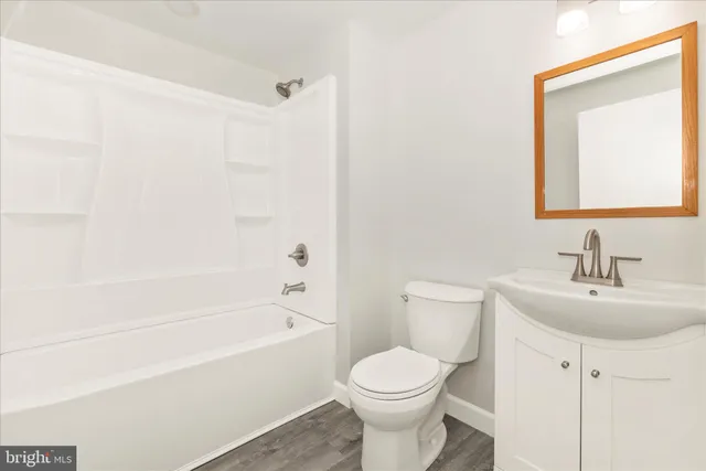 a bathroom with a toilet a sink and bathtub
