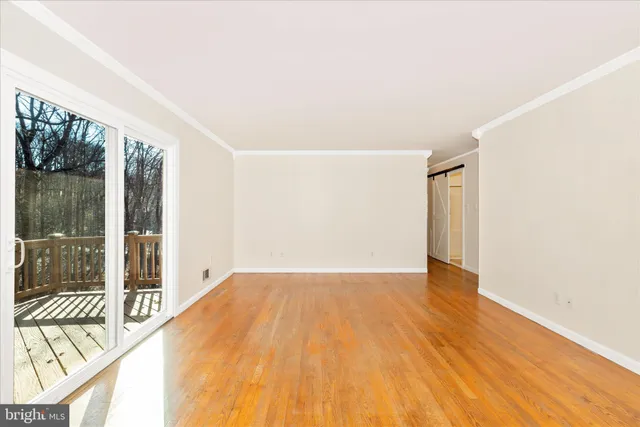 a view of an empty room with glass door