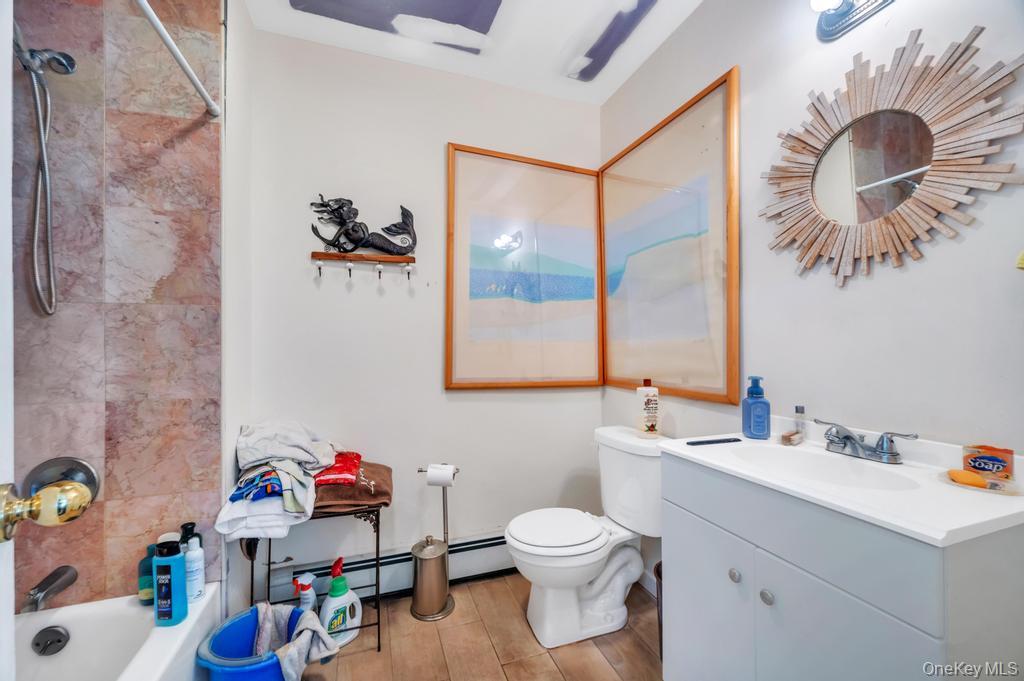 3142 Shore Road Bellmore, NY 11710 - Photo 12 of 24 a bathroom with a sink mirror vanity and toilet