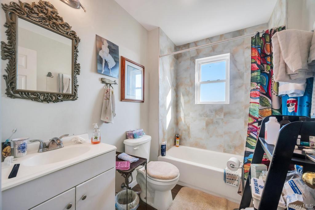 3142 Shore Road Bellmore, NY 11710 - Photo 15 of 24 a bathroom with a sink mirror vanity and toilet