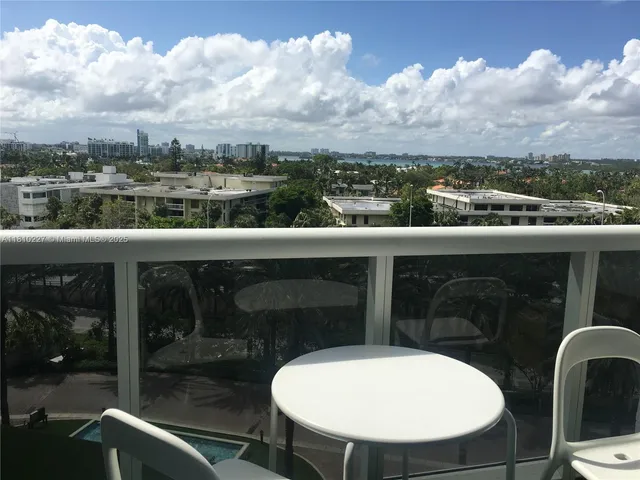 a view of a balcony with table and chairs