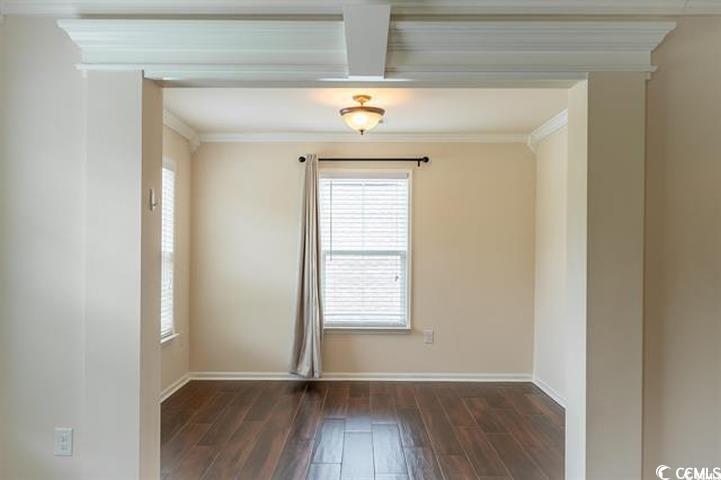 1221 Wind Swept Court Little River, SC 29566 - Photo 13 of 29 Empty room with dark wood-type flooring and orname