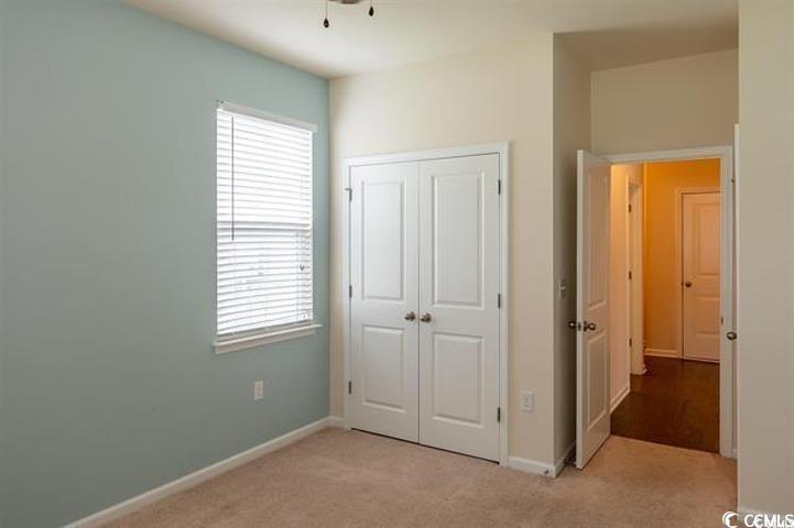 1221 Wind Swept Court Little River, SC 29566 - Photo 17 of 29 Unfurnished bedroom featuring a closet and light c
