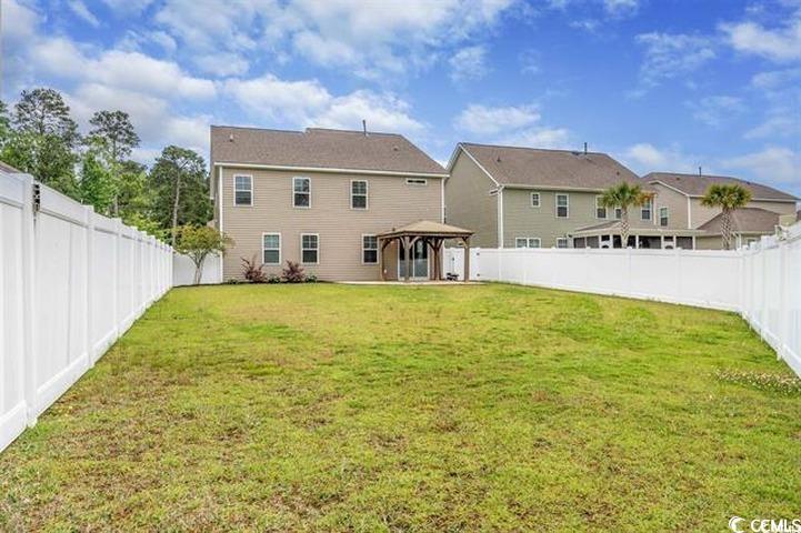 1221 Wind Swept Court Little River, SC 29566 - Photo 18 of 29 Rear view of house with a gazebo and a yard
