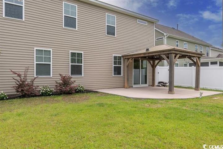 1221 Wind Swept Court Little River, SC 29566 - Photo 24 of 29 Back of house with a lawn, a patio area, and a gaz