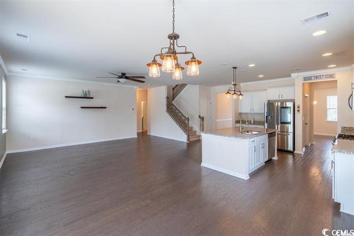 1221 Wind Swept Court Little River, SC 29566 - Photo 26 of 29 Kitchen with light stone countertops, white cabine