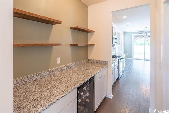 1221 Wind Swept Court Little River, SC 29566 - Photo 5 of 29 Kitchen with white cabinetry, light stone countert