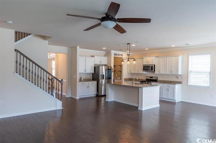 1221 Wind Swept Court Little River, SC 29566 - Photo 6 of 29 Kitchen featuring white cabinets, dark hardwood /