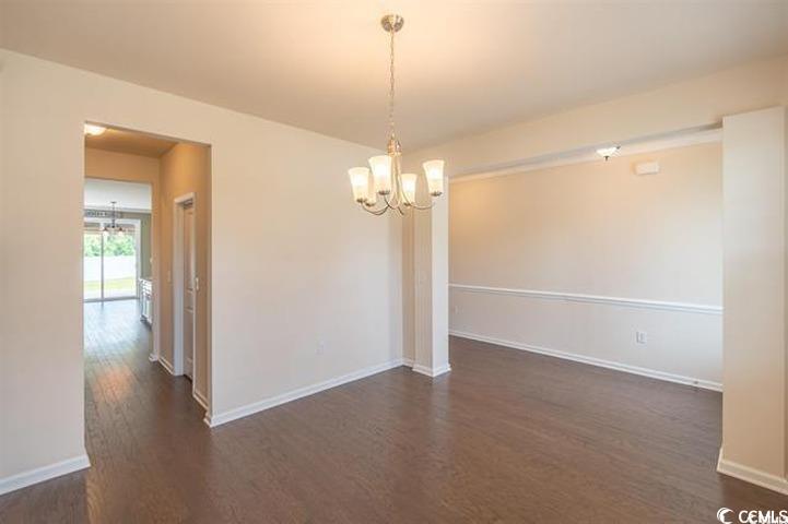 1221 Wind Swept Court Little River, SC 29566 - Photo 8 of 29 Empty room with dark hardwood / wood-style floorin