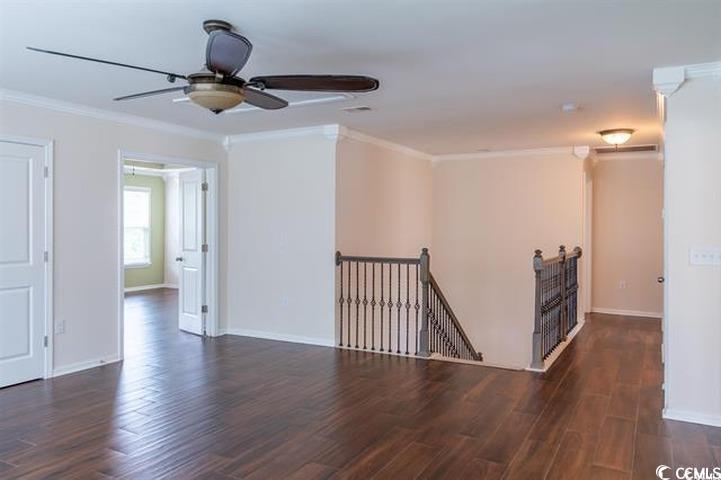 1221 Wind Swept Court Little River, SC 29566 - Photo 9 of 29 Empty room with ceiling fan, dark wood-type floori