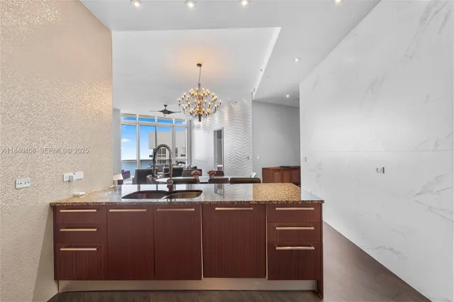 a view of a dining room with furniture wooden floor and chandelier