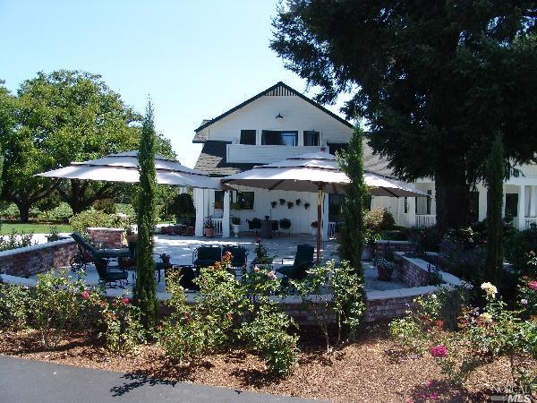 a front view of a house with a yard garage and outdoor seating
