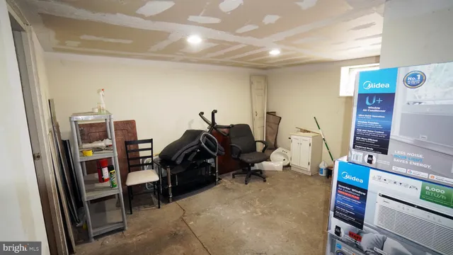 a living room with furniture a flat screen tv and a large window