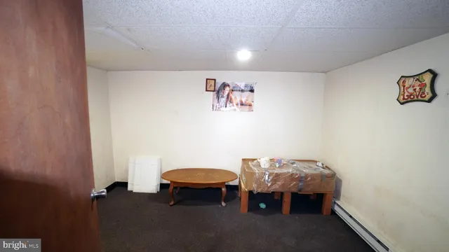 a view of a room with furniture and a table