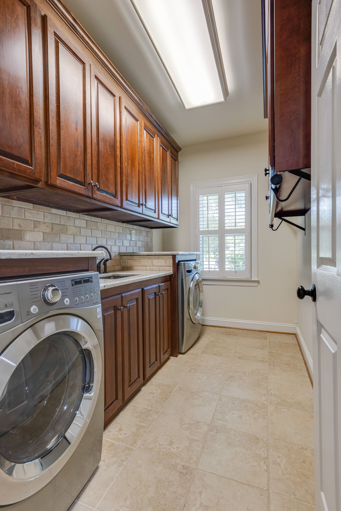 200 Eiderdown Drive Franklin, TN 37064 - Photo 22 of 45 a kitchen with stainless steel appliances granite countertop a sink a washer and dryer next to a window