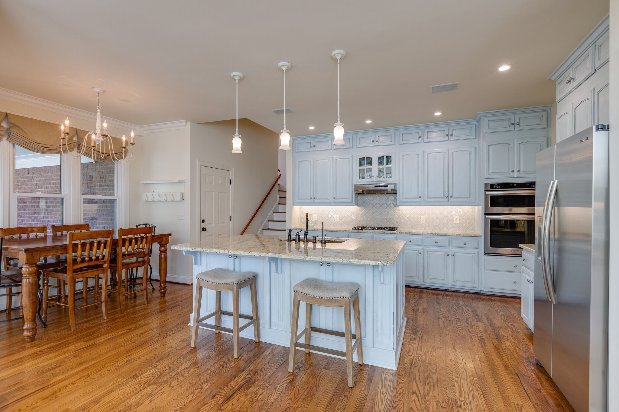 200 Eiderdown Drive Franklin, TN 37064 - Photo 9 of 45 a large kitchen with a table and chairs
