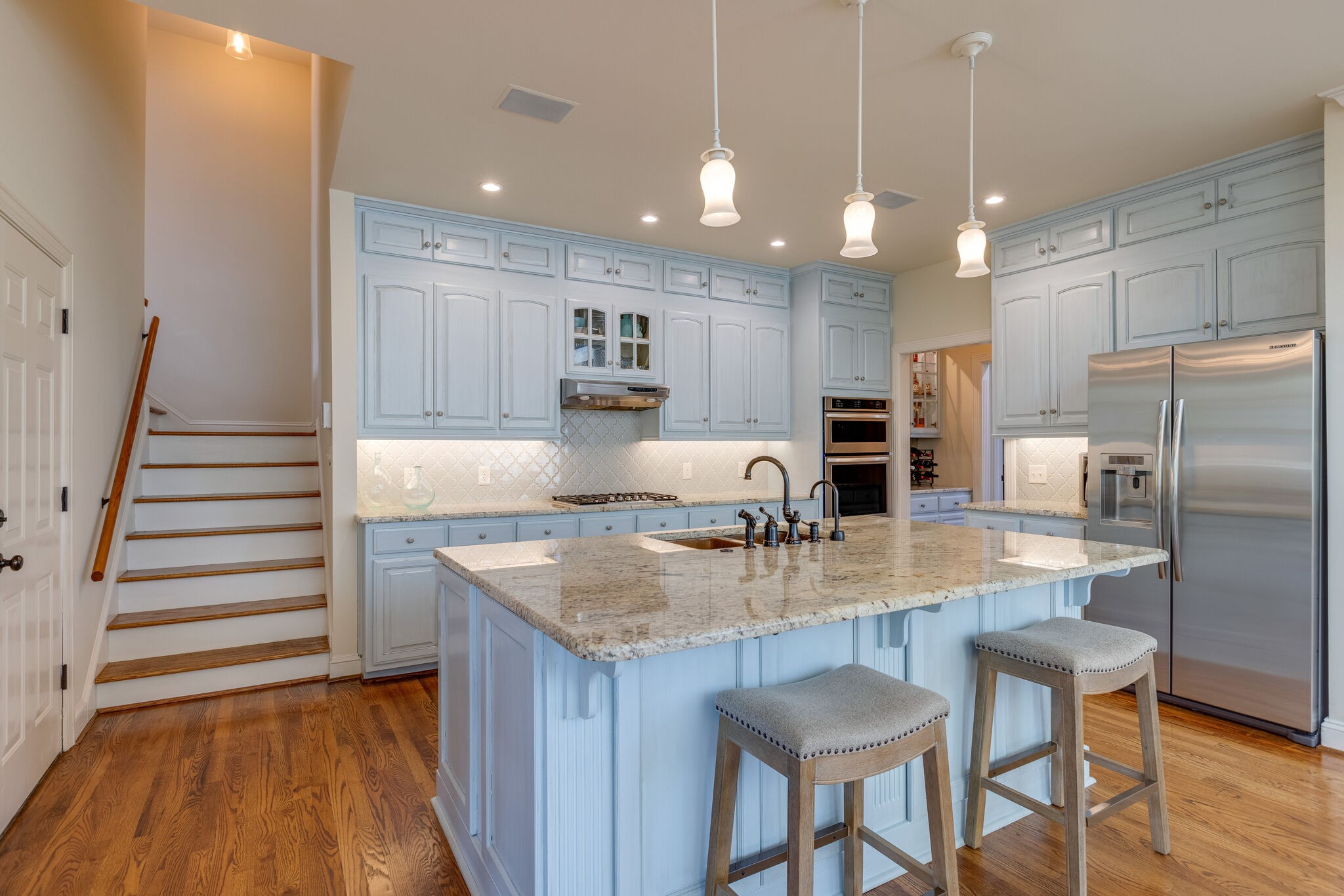 200 Eiderdown Drive Franklin, TN 37064 - Photo 10 of 45 a kitchen with kitchen island granite countertop a sink a refrigerator and a stove
