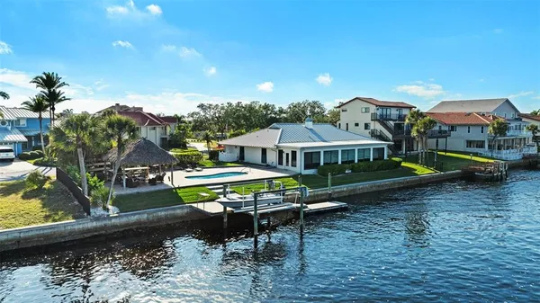 a view of a house with backyard porch and sitting area