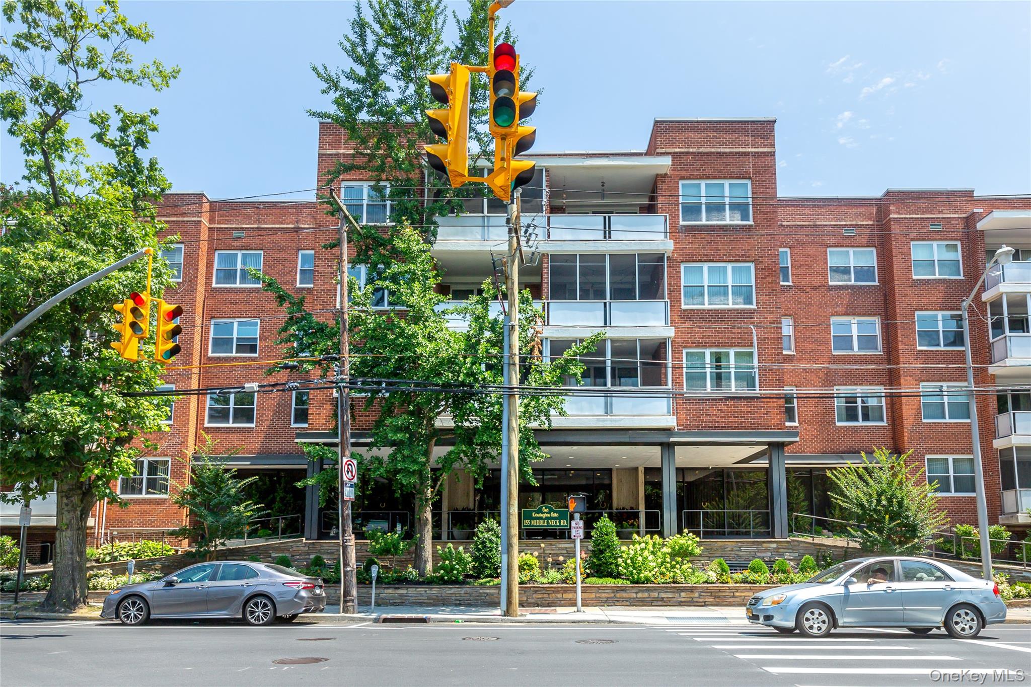 1 Kensington Gate, Unit 302 Great Neck, NY 11021 - Photo 16 of 30 a view of street with parked cars