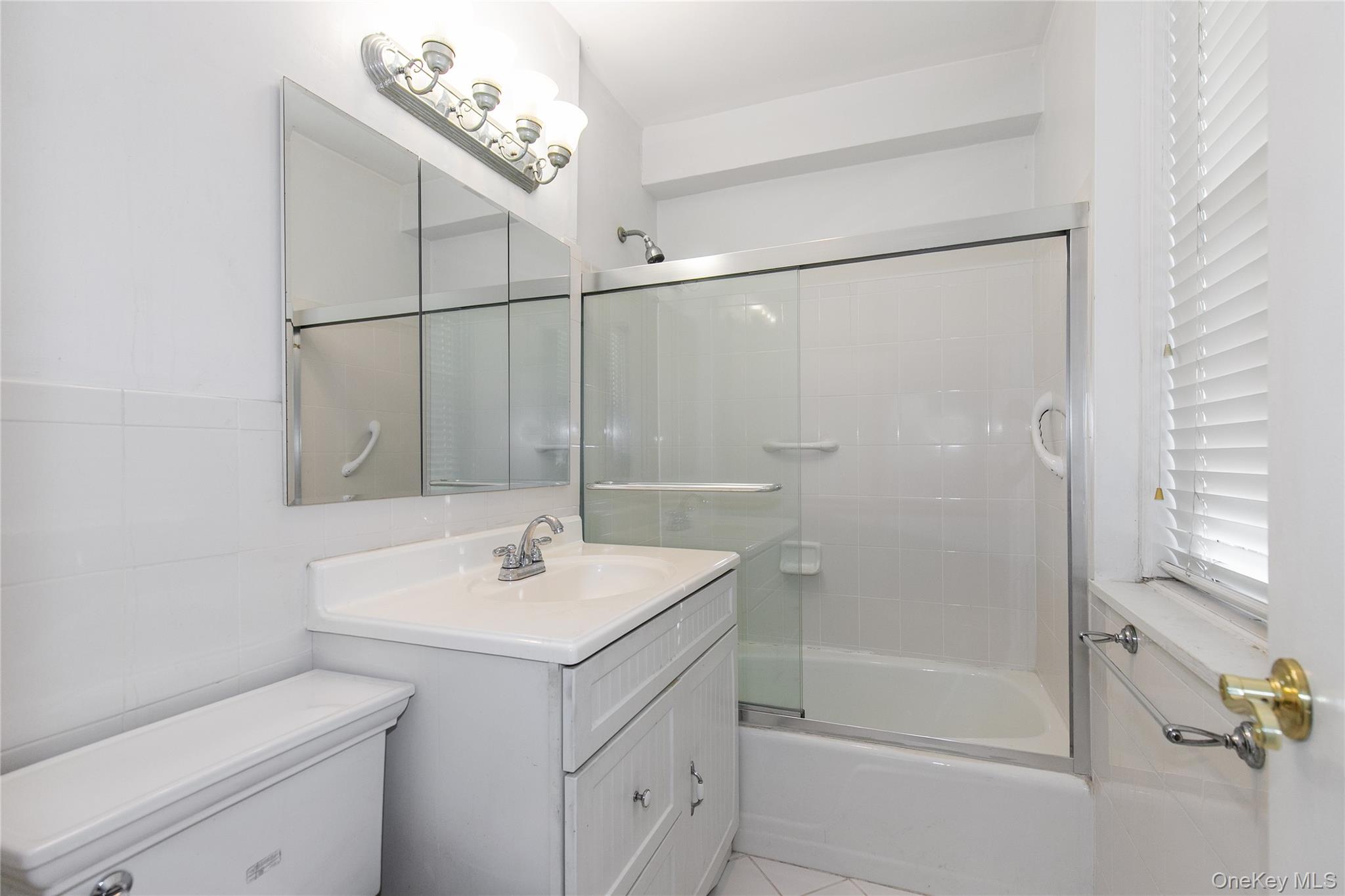 1 Kensington Gate, Unit 302 Great Neck, NY 11021 - Photo 23 of 30 a bathroom with a sink toilet and shower